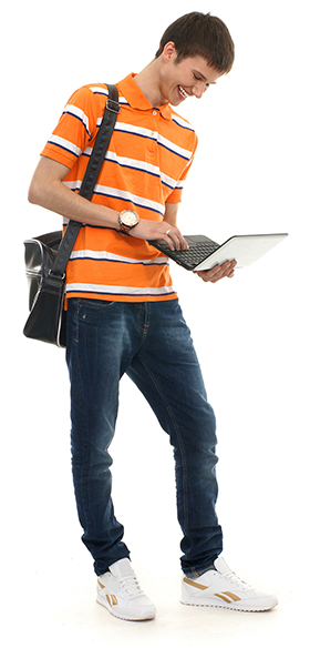 Teenage boy smiling at a laptop